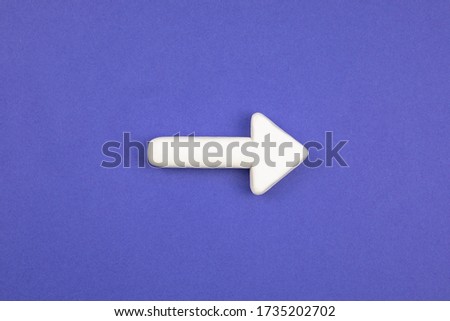 White arrow on the blue background. 3D mockup, pointing direction. Right way concept.