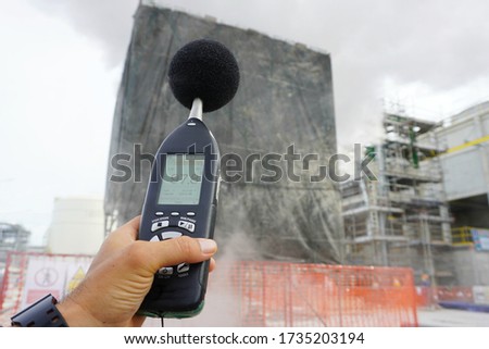 Hand of Environmental officer holding to use sound level meter for monitor is part of the prevention of environmental impacts at Chemical plant area or refinery factory. Royalty-Free Stock Photo #1735203194