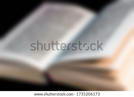Open Talmud Torah Tanakh Book on Hebrew with English translation on table. Blurred background