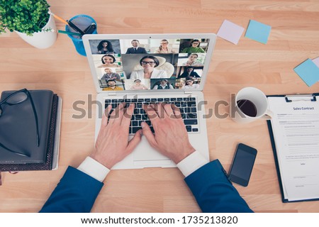 High angle above view cropped photo of young man typing hands arms laptop in home office speaking talking skype online group video call see happy smiling friendly colleagues partners Royalty-Free Stock Photo #1735213820