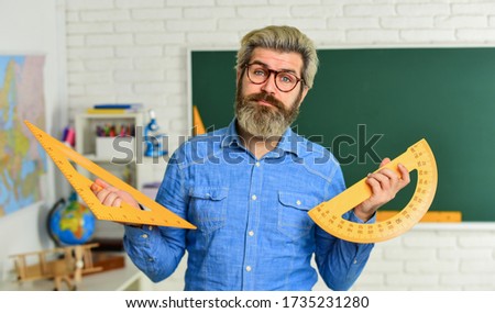 Math subject. Geometry and algebra. Theorem. Talented teacher. Science concept. Mature bearded teacher in glasses. Private lesson. Back to school. Study mathematics. Man mentoring school projects.