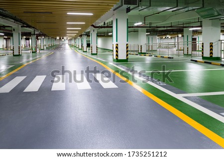 Empty underground parking lot in modern building. Royalty-Free Stock Photo #1735251212