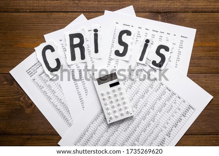 World financial crisis concept - documents, calculator - on wooden background top view