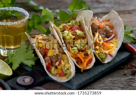 Tacos with different fillings and tequila