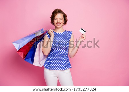 Portrait of her she nice attractive lovely lovable pretty charming glad cheerful cheery brown-haired girl carrying bags new things holding in hand plastic card isolated on pink pastel color background