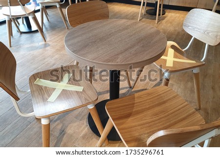 Alternate seating sign in a cafe, keep spaced between each chairs make separate for social distancing to avoid spreading of Covid-19.