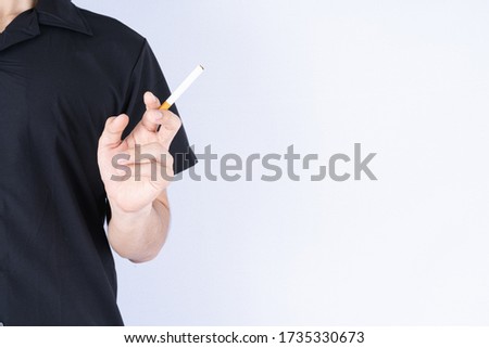 Man hold a cigarette with his hand. Stop smoking campaign. World no tobacco day.