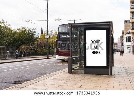 Empty advertising light box. Billboard on a bus stop. Your ad. Bus in background