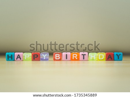 HAPPY BIRTHDAY word written in  cube on wooden floor on white background, letter blocks arranges into HAPPY BIRTHDAY words, for adding text or other images or design