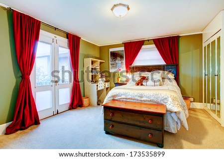 Cute green and red adult room with big wooden bed and rustic storage