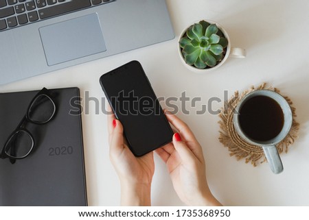 White flatlay of desktop with phone mockup and coffee cup, morning breakfast, scedualing in 2020