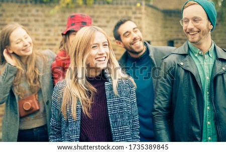 Happy Group of friends walking on the street. Young people hanging out ready for party night. Millennial people smiling - Friendship and youth concept - Image