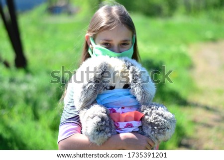 Little girl in a mask during a virus pandemic. Wear a mask to prevent the spread of the virus.
