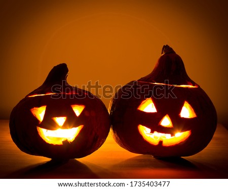 Beautiful fabulous view: pumpkins and lighted candles in the night. Amazing illumination holiday Halloween. Event traditional celebration.