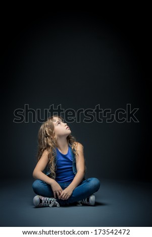 Little girl looking up in studio