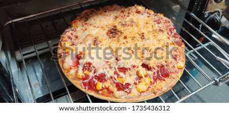 Pizza being baked in oven