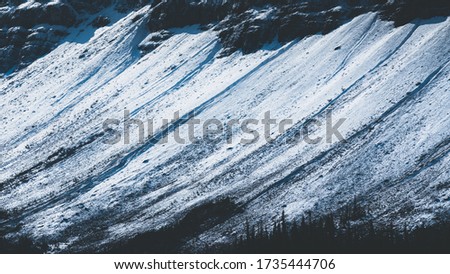 Beautiful background of snow at the bottom of the moutain in vintage style.