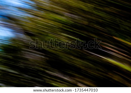 Futuristic nature in motion: natural environment multicolor light streaks with a touch of light blue sky - abstract eighth rotational motion blurred background, texture