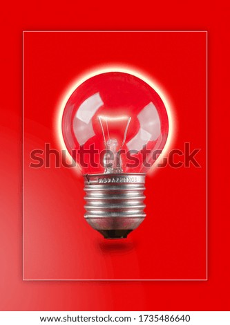 Light bulb close up on red background
