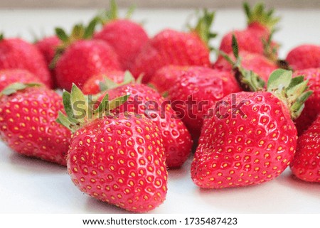 macro photo of strawberries with ponytails