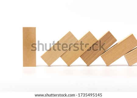 Wooden block standing and outstanding among the collapse of fall in line, business concept able to survive or dominant from destruction