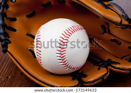 Baseball and mitt on rustic wooden background