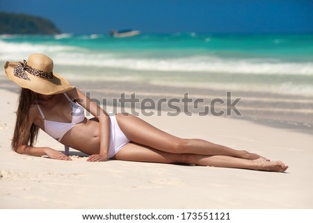 Young Woman Sunbathing At Tropical Beach