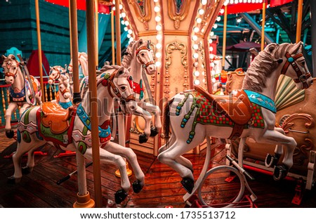 A night shot of a merry Go round, on a rainy night.  Royalty-Free Stock Photo #1735513712