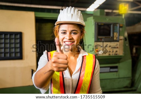 Professional technicians and engineers wearing protective clothing showing thumbs up. Technician in the industry at machine maintenance working congratulation.
