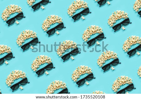 Pattern made with abstract image of viewer, 3D glasses and popcorn on blue background. Creative concept cinema movie and entertainment Flat lay Top view.