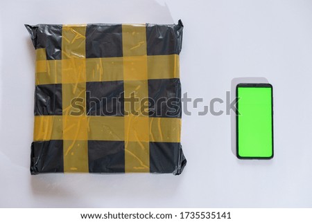 delivery  package and phone with green screen on white background. tracking concept design