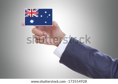 Businessman hand holding a business card with Australia flag and clipping path