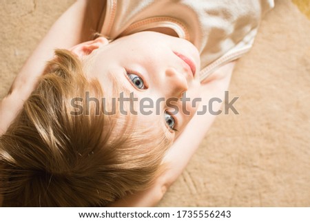Portrait of little child with beautiful eyes and blond hair