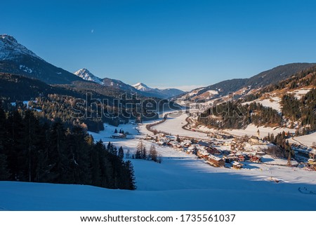 Winter landscape in Tre Cime Dolomiti, or Drei Zinnen Dolomites. Monte Elmo Sesto , Italy. January 2020. Top view on San Candido. Royalty-Free Stock Photo #1735561037