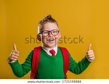 Funny school boy making thumb up