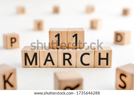 March 11 - from wooden blocks with letters, important date concept, white background random letters around
