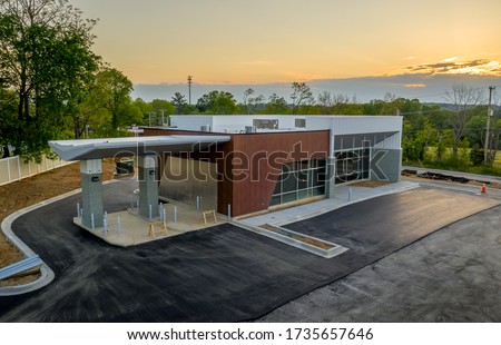 Aerial view of newly constructed bank branch commercial real estate building with drive through ATM lanes Royalty-Free Stock Photo #1735657646