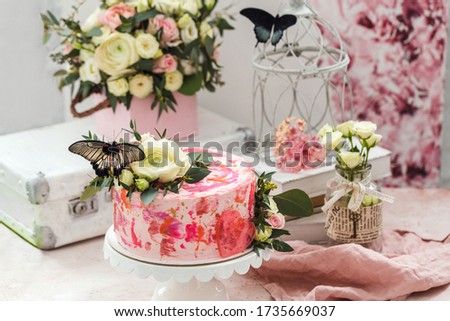 Pink cake decorated with flowers and real butterflies rose romantic atmosphere