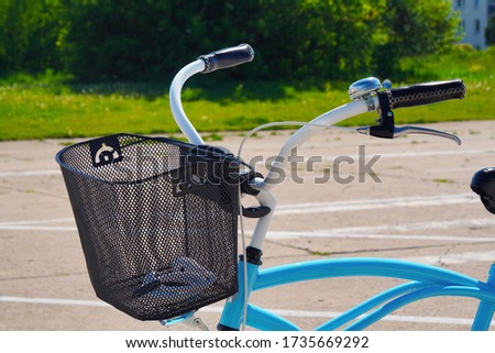 Blue city bike with a basket for food or things on the street with low houses, ease of movement around the city. eco-friendly mode of transport.