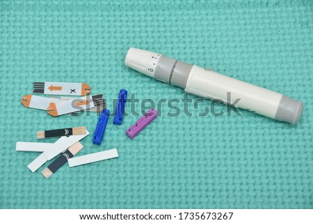 Lancet pen ,Diabetes Glucose Test Strip.Blood Glucose Test Strips Royalty-Free Stock Photo #1735673267