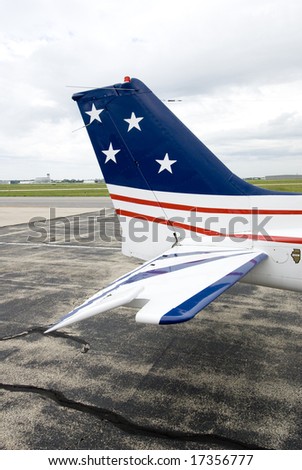 Picture of a tail of an aircraft with red, white and blue paint