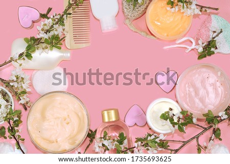 Spa ingredients, a set of cosmetic oils and cosmetics for skin and body care on a pink background. Shopping concept and modern woman, sale, top view, selective focus