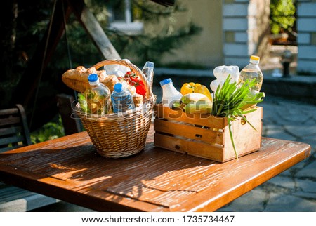 Social food kits for the elderly. A basket of groceries is on the table