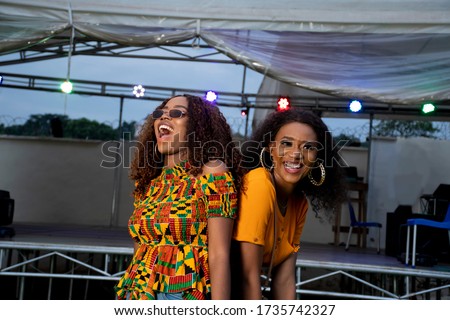 two black girls dancing at a concert held at night Royalty-Free Stock Photo #1735742327