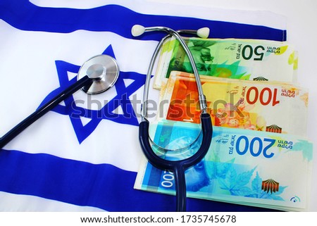 Healthcare and medical concept. Medical Tourism in Israel, payment for treatment, bills, medical services, Private medicine. Stethoscope, Israeli shekel banknotes on the background of the flag Israel
