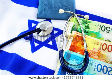 Medical concept. Private medicine in Israel, payment for treatment. Stethoscope, Shekel banknotes, Passport Israel (translate Hebrew/ Arabic text on a booklet - Ministry of Interior, ID), flag Israel