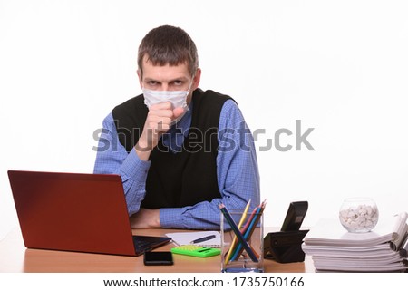 Office worker in a protective mask coughs in the office