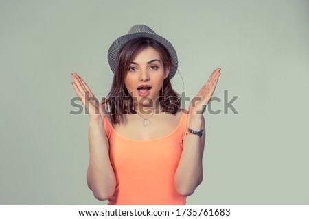 Lucky girl. Closeup portrait happy young woman happy exults hands up looking ecstatic isolated green wall background. Celebrate success concept. Human facial expression emotions feelings body language