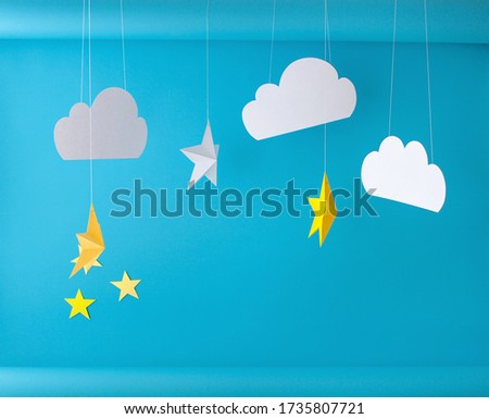 Paper background for birthday baby photoshoot. Blue sky and handmade paper cutting stars.
