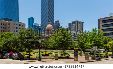 Houston TX USA - May 2020: Cupola atop the 1910 Courthouse flanked by the Family Law and Juvenile Justice Centers. The Houston skyline includes JP Morgan Chase Tower (1982) and 609 Main Street (2017)